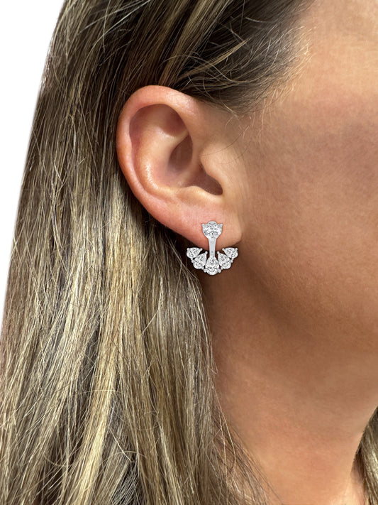 Close-up of a woman wearing real certified diamond cluster earrings in white gold, showcasing fine diamond jewelry in NYC